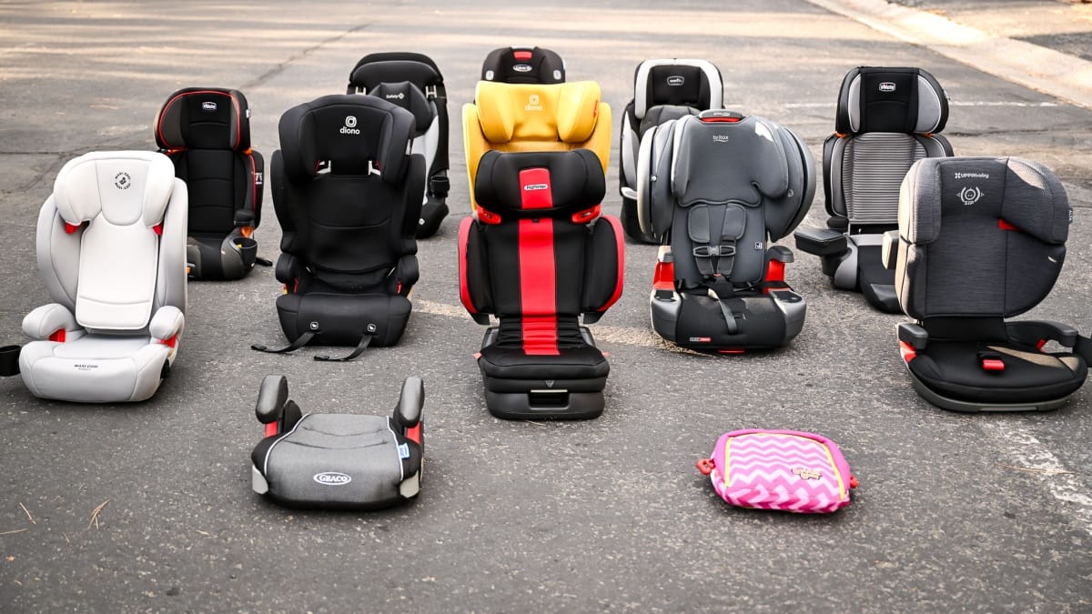 Rear-facing, forward-facing and booster child car seats lined up for limo and car service rides