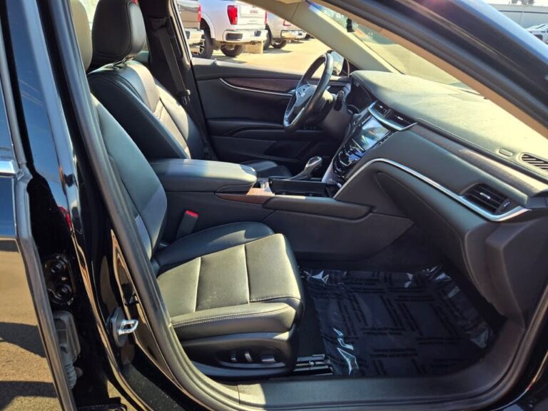 Front seats of Black luxury sedan with leather interior for executive and airport transfers.